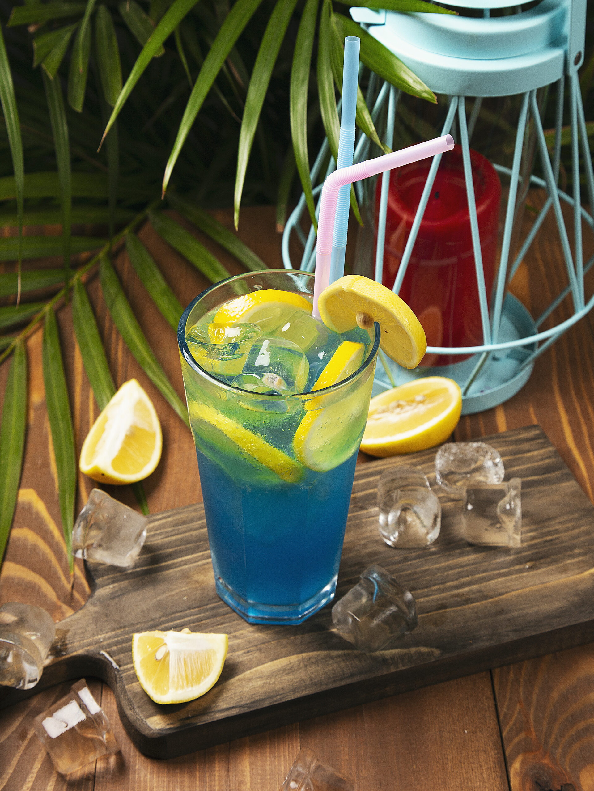 Closeup glass of blue lagoon cocktail decorated with lime at festive bar counter background. - Image